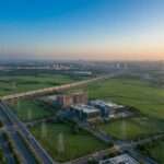 Main banner for blog on the best place to invest in land in India 2026, highlighting infrastructure capex growth, RBI rate stability, freight corridor development, and corridor-based land investment strategy.